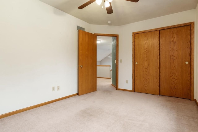 unfurnished bedroom with carpet, a closet, visible vents, ceiling fan, and baseboards