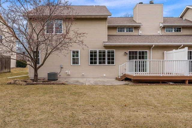 back of property with cooling unit, a lawn, fence, and a patio