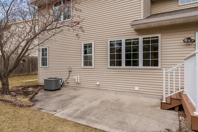 view of property exterior featuring a patio area, fence, and cooling unit