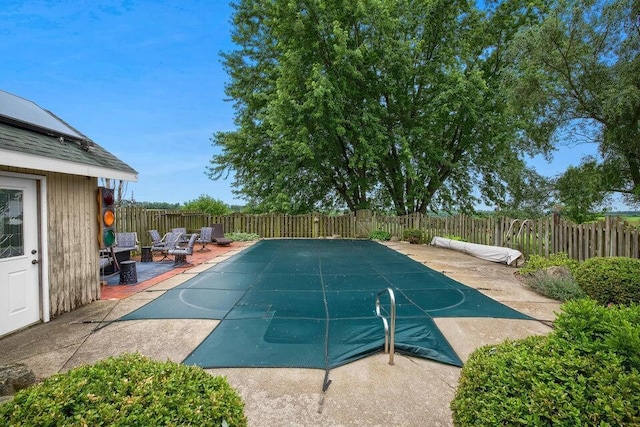 view of swimming pool featuring a fenced backyard and a patio