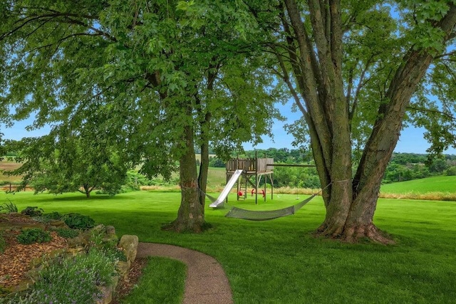 view of home's community with a lawn and a playground