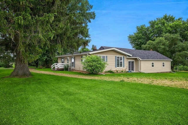 ranch-style home with a front yard and a chimney