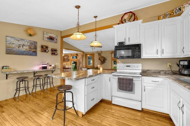 kitchen with black microwave, a peninsula, white electric range oven, and white cabinets