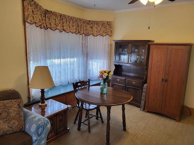 interior space featuring ornamental molding, carpet, and a ceiling fan