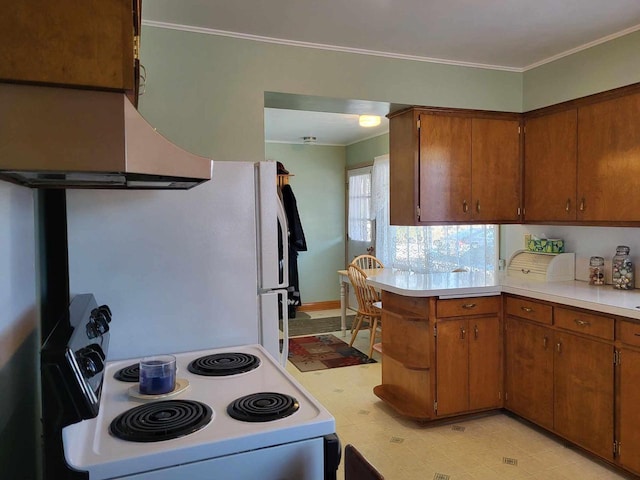 kitchen with electric stove, light floors, light countertops, brown cabinetry, and a peninsula