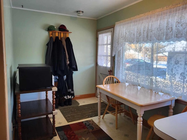 dining room with baseboards and ornamental molding