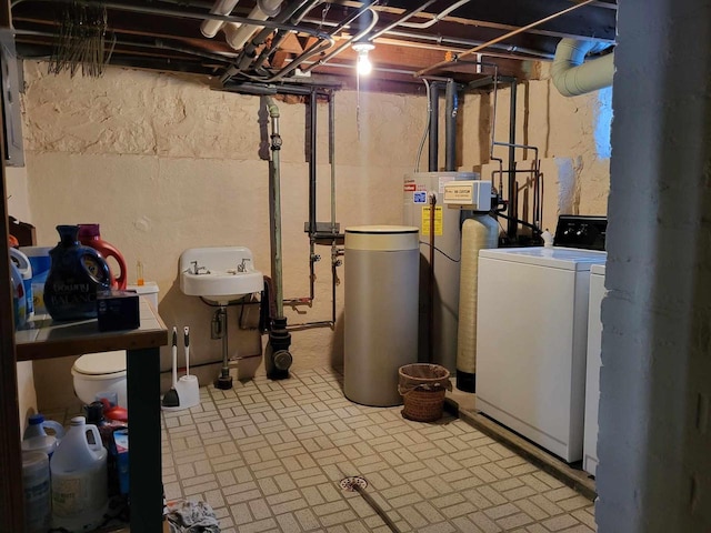 unfinished below grade area with a sink and washing machine and clothes dryer