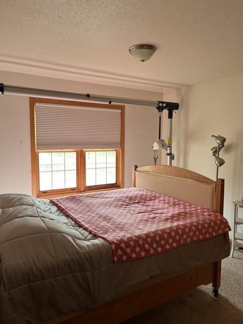 carpeted bedroom featuring a textured ceiling