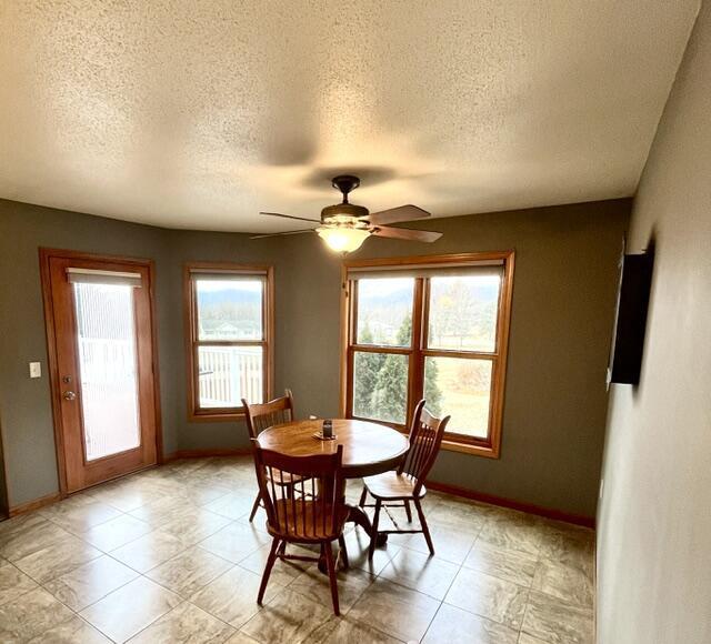 dining room with baseboards and a ceiling fan