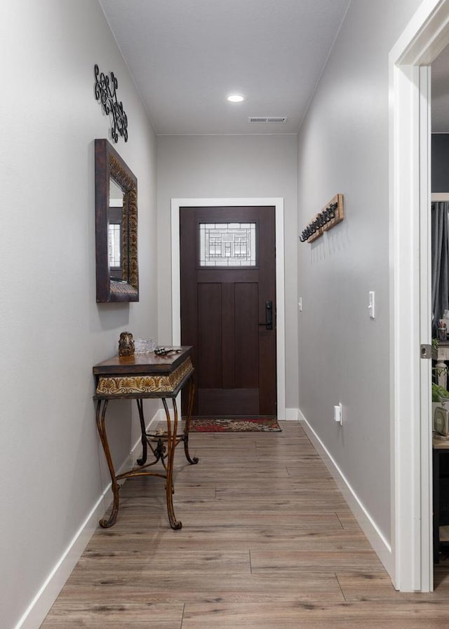 foyer featuring light wood-style flooring, recessed lighting, visible vents, and baseboards