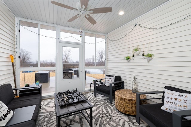 sunroom featuring wood ceiling, plenty of natural light, and ceiling fan