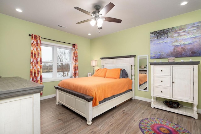 bedroom featuring recessed lighting, visible vents, baseboards, and wood finished floors