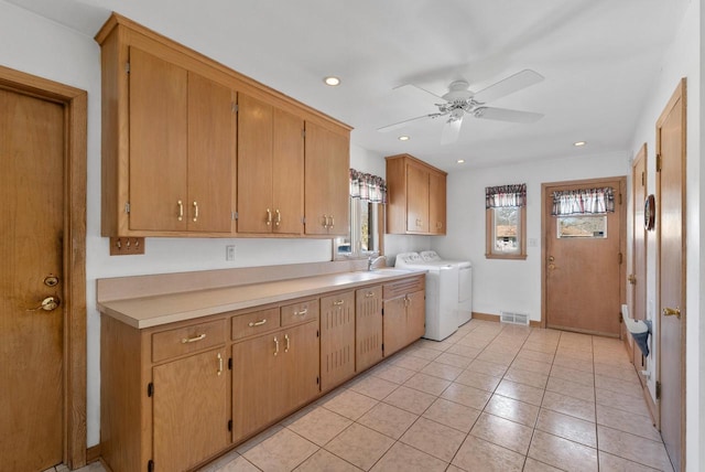 interior space with visible vents, recessed lighting, cabinet space, a sink, and independent washer and dryer