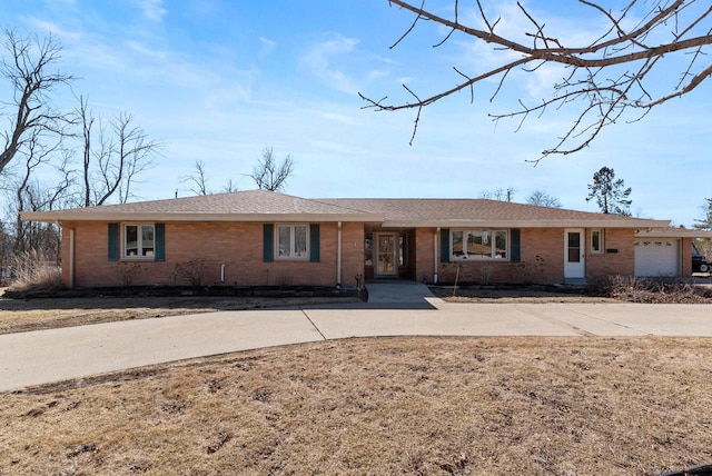 ranch-style home featuring brick siding and an attached garage