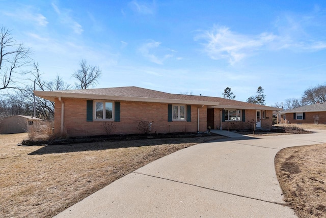 single story home with brick siding and concrete driveway