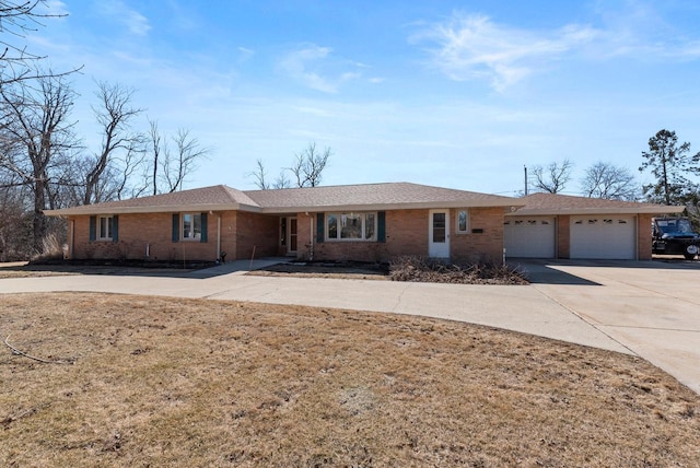 single story home featuring brick siding, an attached garage, and concrete driveway