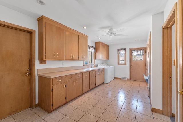 kitchen featuring a ceiling fan, visible vents, separate washer and dryer, a sink, and light countertops