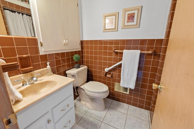 full bath with vanity, visible vents, tile walls, toilet, and tile patterned floors