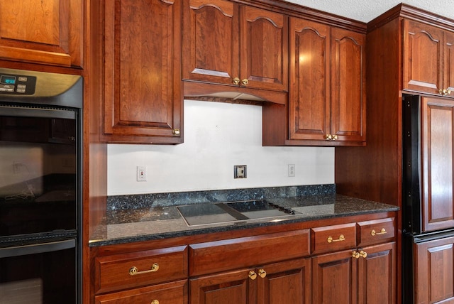 kitchen featuring dark stone counters and black appliances