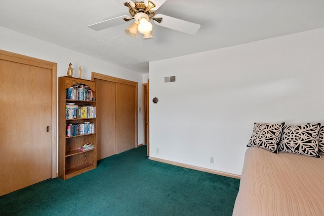 carpeted bedroom with a ceiling fan, visible vents, and baseboards