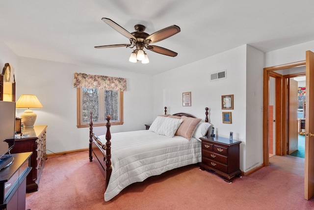 bedroom with visible vents, light carpet, baseboards, and ceiling fan