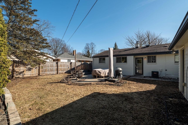 view of yard featuring a patio area, fence, and central AC