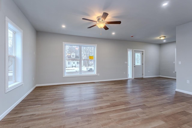 unfurnished living room featuring a ceiling fan, baseboards, wood finished floors, and recessed lighting