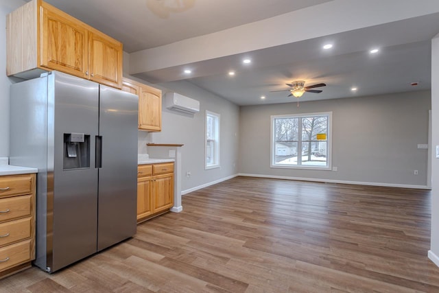 kitchen featuring light wood-style flooring, recessed lighting, light countertops, a wall mounted AC, and stainless steel refrigerator with ice dispenser