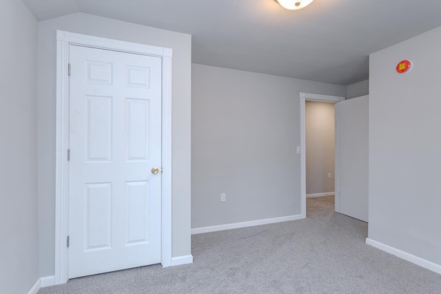 unfurnished bedroom featuring carpet and baseboards