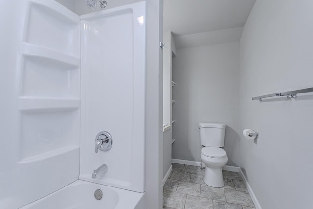 full bath with washtub / shower combination, toilet, and baseboards