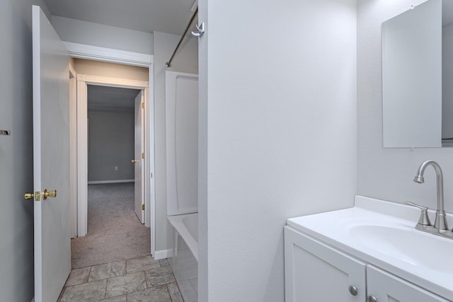 full bathroom with vanity and baseboards