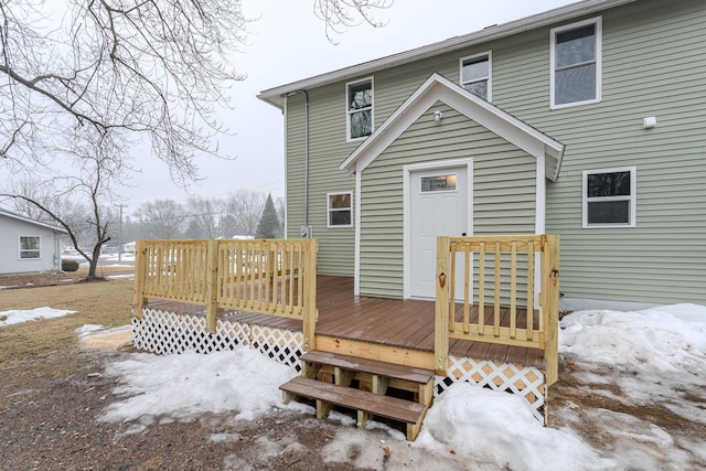 snow covered property with a deck