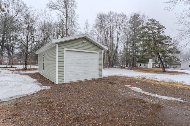 snow covered garage with a garage