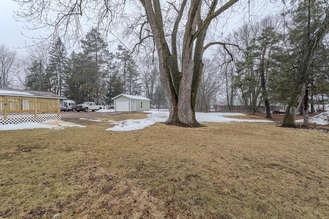 view of yard with a garage, an outdoor structure, and a wooden deck