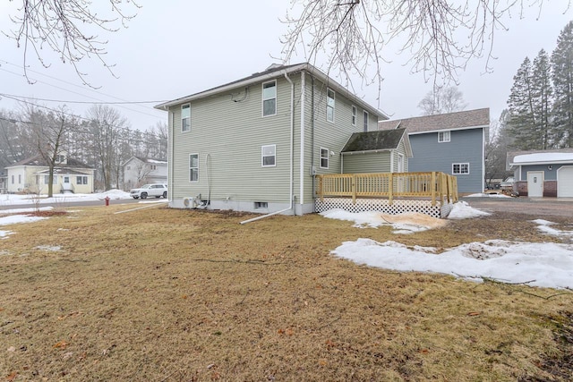 rear view of property with a deck and a yard