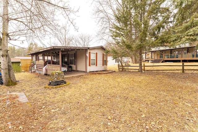 rear view of house featuring a wooden deck