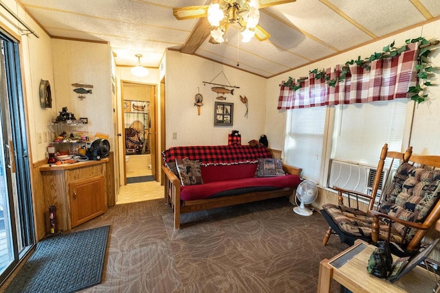 carpeted living area featuring ceiling fan, vaulted ceiling, and crown molding