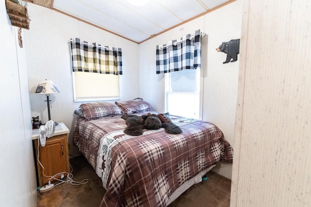 bedroom featuring vaulted ceiling, dark carpet, and crown molding