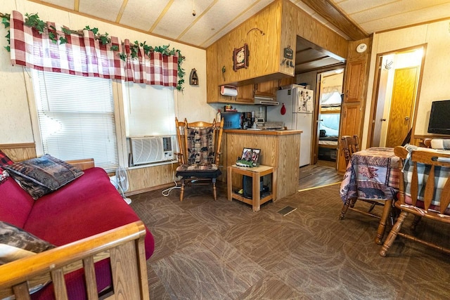 kitchen featuring brown cabinets, dark colored carpet, visible vents, freestanding refrigerator, and cooling unit