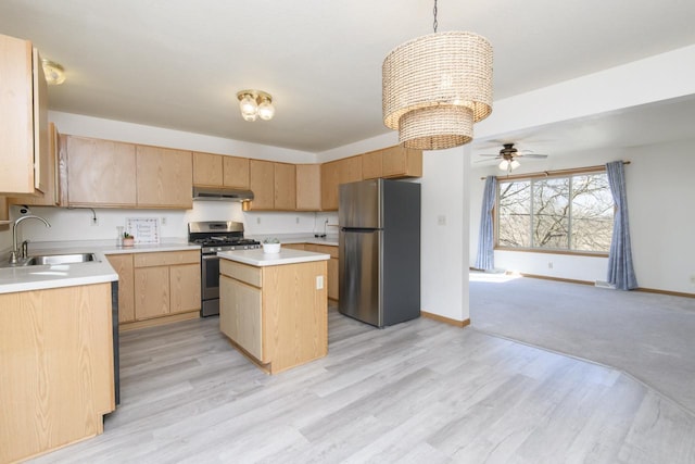 kitchen featuring a sink, under cabinet range hood, a center island, appliances with stainless steel finishes, and light countertops