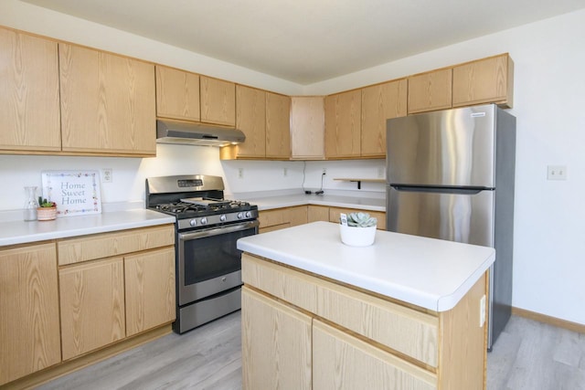 kitchen featuring under cabinet range hood, stainless steel appliances, light wood-style floors, and light brown cabinets