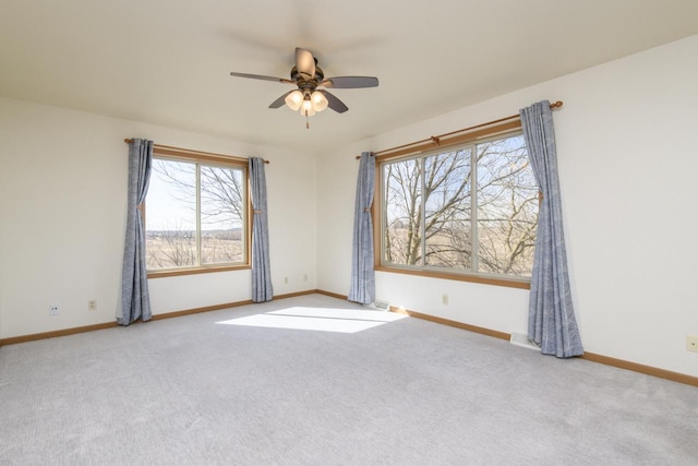 unfurnished room with baseboards, a ceiling fan, and carpet flooring