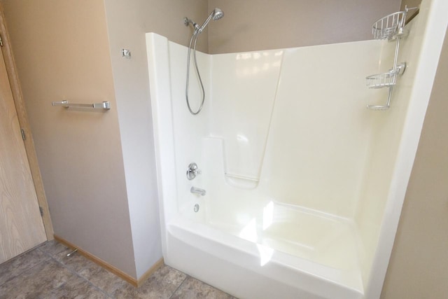 bathroom featuring baseboards, shower / tub combination, and tile patterned flooring