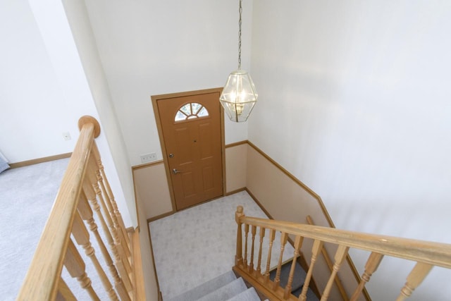 carpeted entryway with baseboards