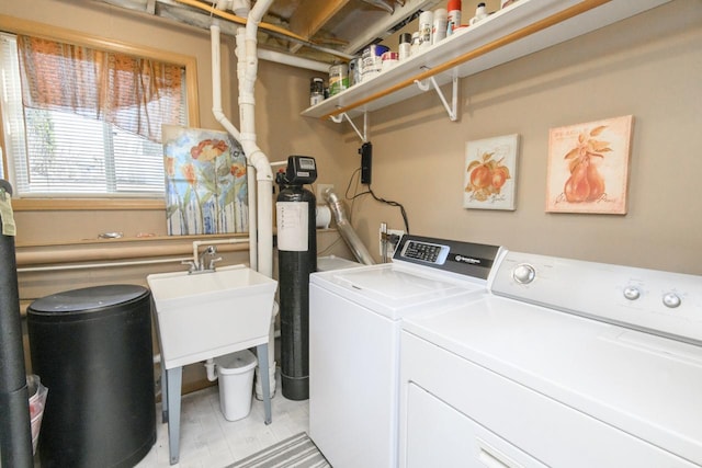 washroom featuring laundry area, independent washer and dryer, and a sink