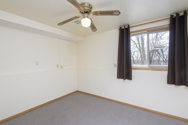 spare room featuring baseboards, carpet floors, and ceiling fan