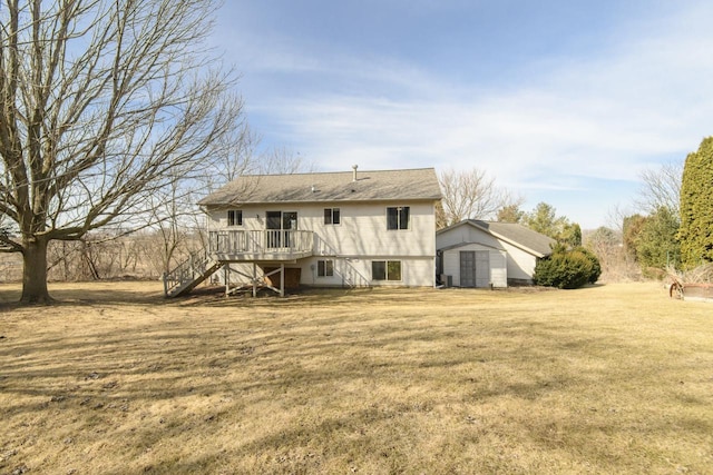 back of property featuring a storage unit, a deck, a yard, an outdoor structure, and stairs