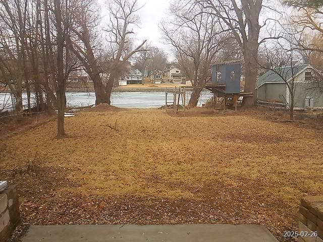 view of yard featuring a water view and a residential view