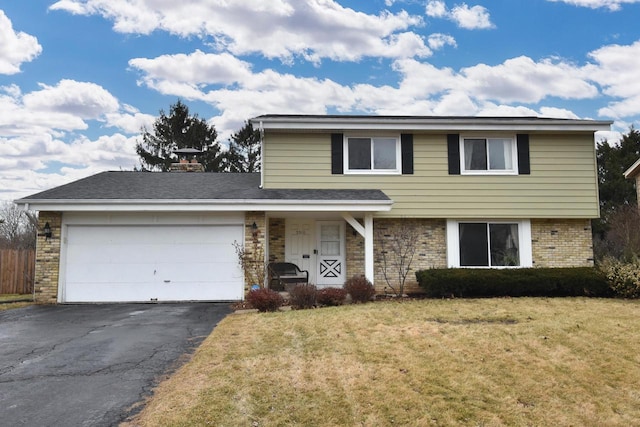 traditional-style house featuring aphalt driveway, brick siding, an attached garage, and a front lawn