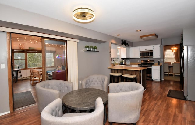 dining area featuring dark wood-type flooring